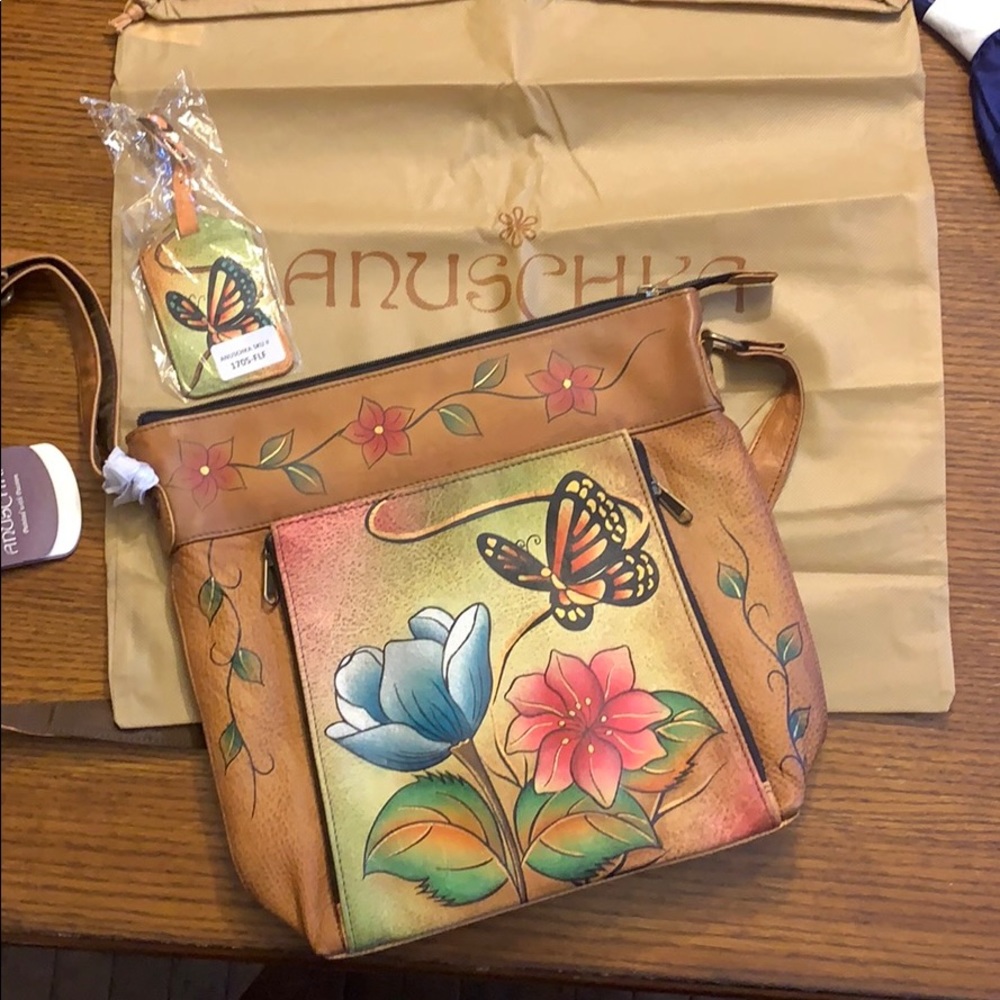 Anuschka crossbody handbag with luggage tag.  NWT